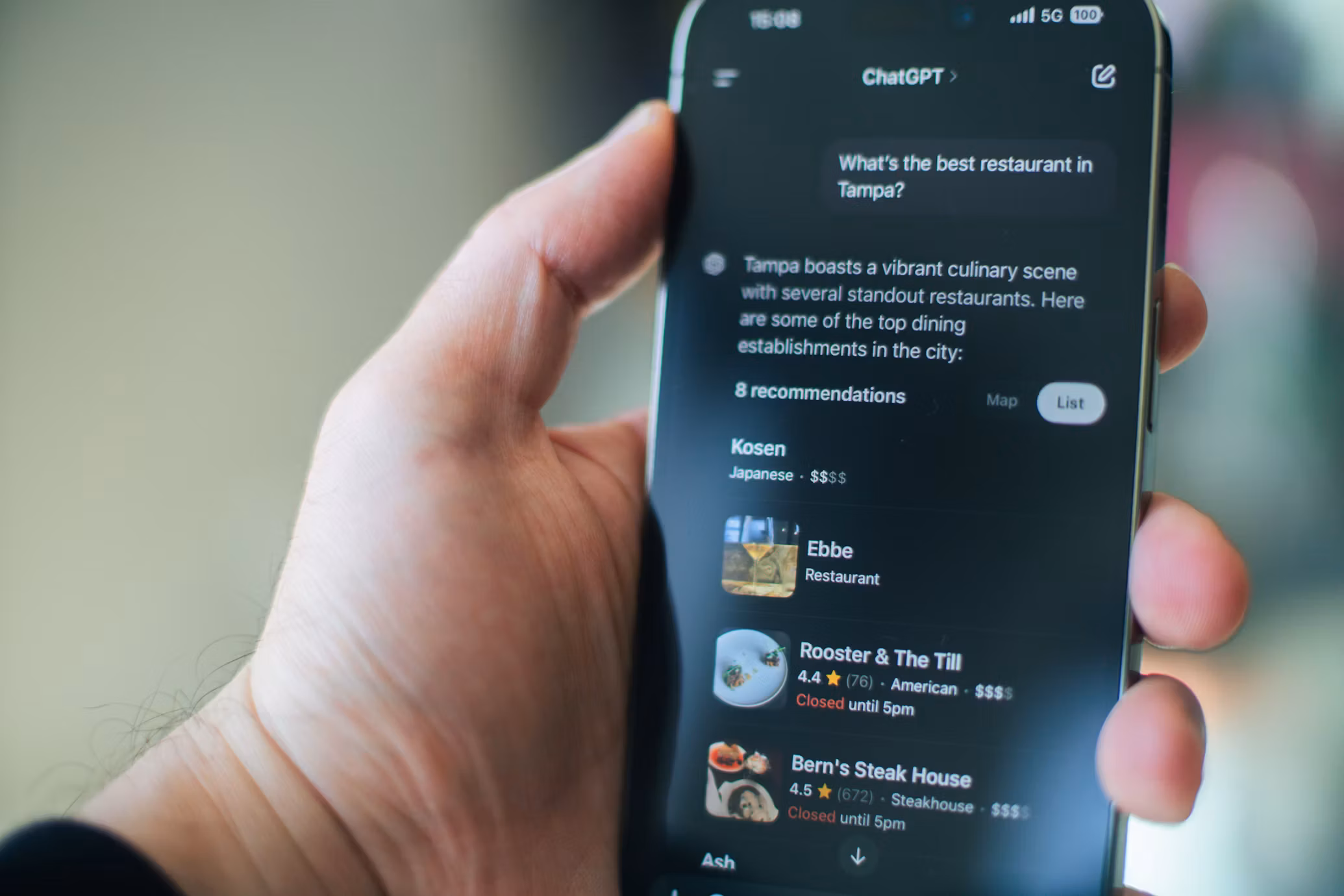 Person holding a phone showing ChatGPT recommending the best restaurants in Tampa, demonstrating how AI assistants now answer local business queries